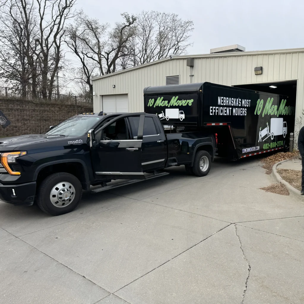10 Men Movers truck and trailer parked outside a secure facility — offering reliable, full-service storage in Omaha with professional on-site crews.